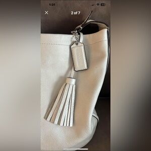 Cream colored leather Coach purse.